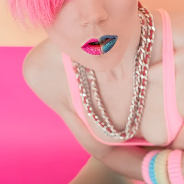 Stylish punk girl with colored hair and bright makeup