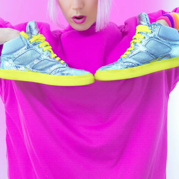 Girl with neon silver fashion sneakers. glam style