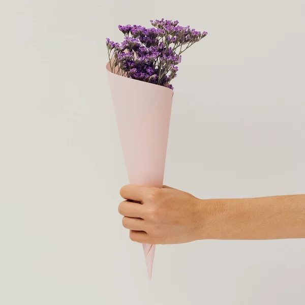 Hand holding field flowers. Minimalism Style details