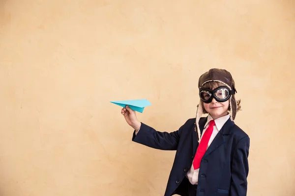 Young businessman with paper airplane