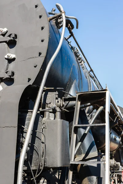 Closeup view of a mechanical equipment aroun a steam locomotive