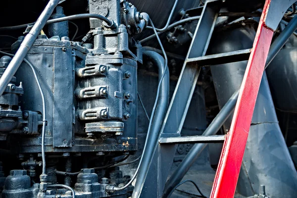 Closeup view of a mechanical equipment around a steam locomotive