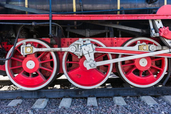Closeup view of steam locomotive wheels, drives, rods, links and