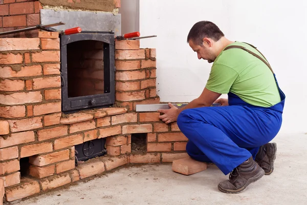 Construction worker building a masonry heater