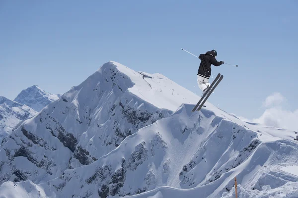 Skier on mountains, extreme jump. Winter sport.