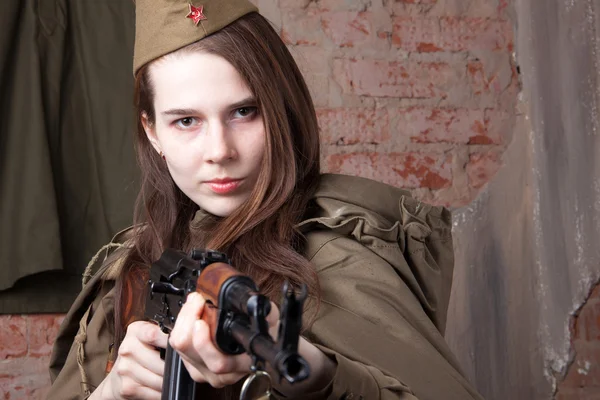 Woman in Russian military uniform shoots a rifle. Female soldier during the second world war.