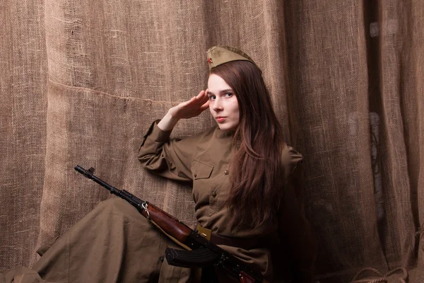 Woman in Russian military uniform with rifle. Female soldier during the second world war.