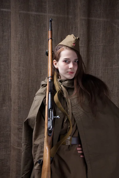 Woman in Russian military uniform with rifle. Female soldier during the second world war.