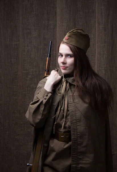 Woman in Russian military uniform with rifle. Female soldier during the second world war.