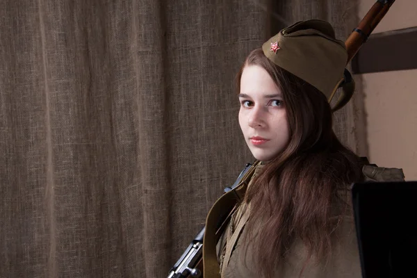 Woman in Russian military uniform with rifle. Female soldier during the second world war.