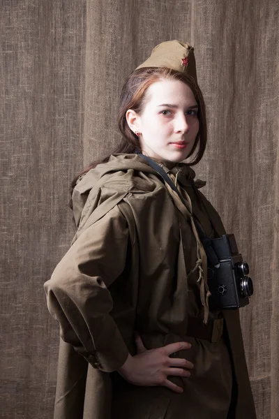 Woman in Russian military uniform with camera. Female war correspondent during the second world war.