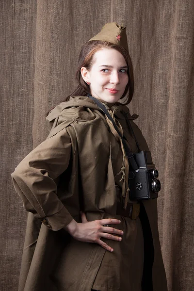 Woman in Russian military uniform with camera. Female war correspondent during the second world war.