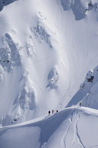 Snowboard freeride, snowboarders and tracks on a mountain slope. Extreme winter sport.