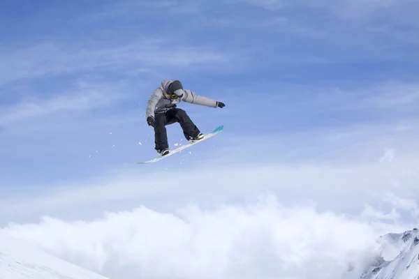 Snowboard rider jumping on mountains. Extreme snowboard freeride sport.