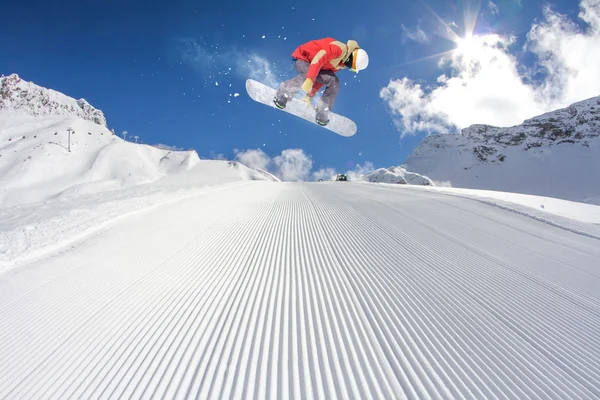 Snowboard rider jumping on mountains. Extreme snowboard freeride sport.