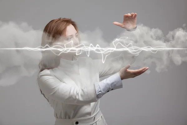 Woman making magic effect - flash lightning. The concept of electricity, high energy.