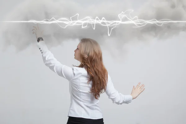 Woman making magic effect - flash lightning. The concept of electricity, high energy.