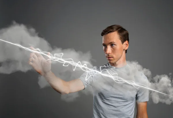Man making magic effect - flash lightning. The concept of electricity, high energy.