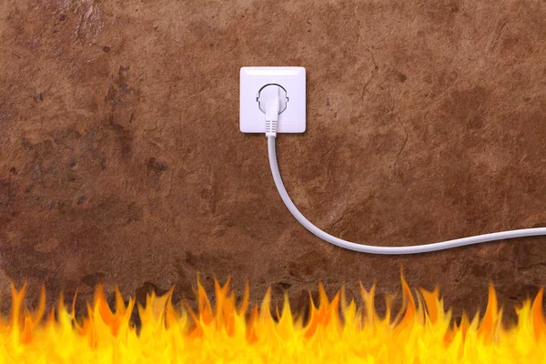 Grunge wall with an electrical outlet and fire