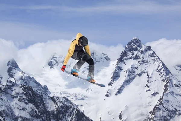 Flying snowboarder on mountains