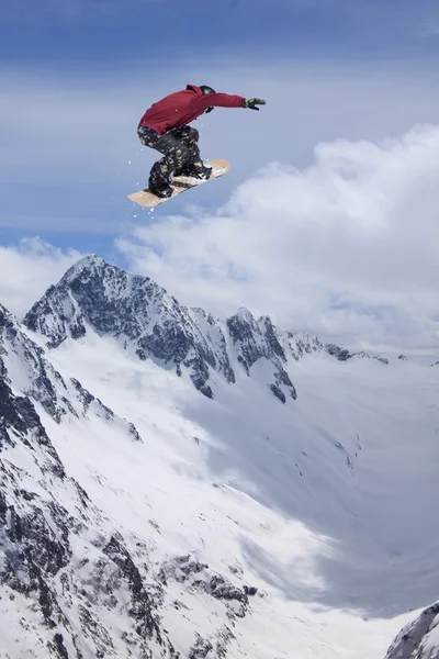 Flying snowboarder on mountains, extreme sport