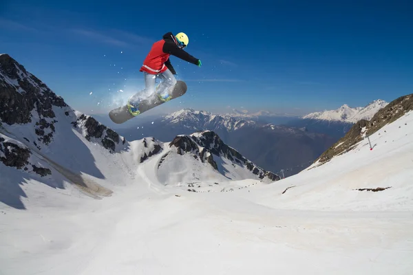 Flying snowboarder on mountains