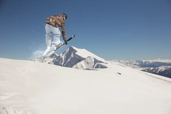 Flying skier on mountains. Extreme sport.