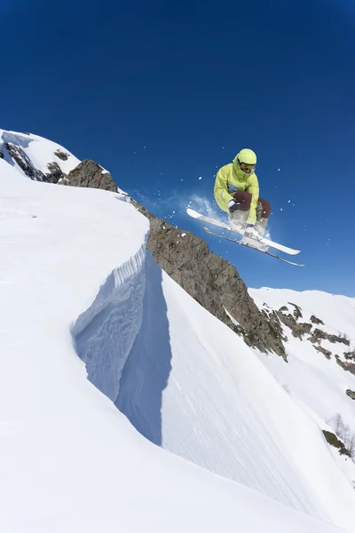 Flying skier on mountains. Extreme sport.