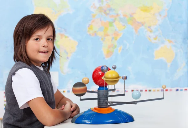 Young schoolboy learning about the solar system