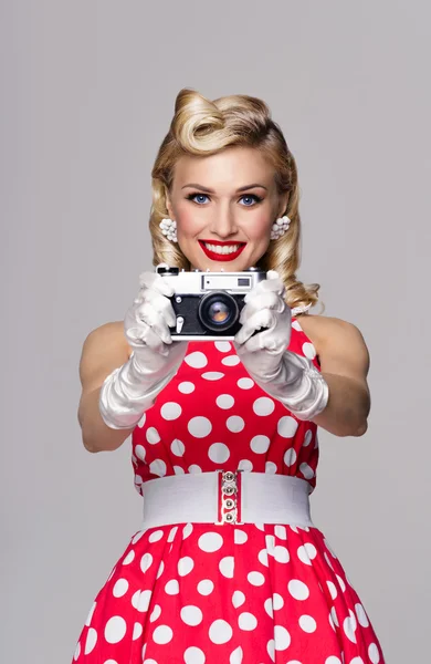Woman, with no-name camera, taking picture, dressed in pin-up st