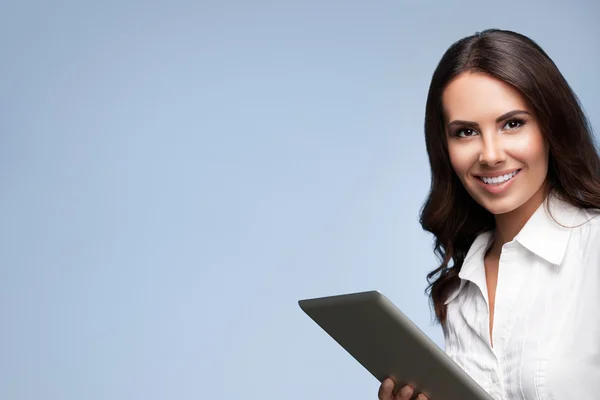 Beautiful young businesswoman using no-name tablet pc, over grey