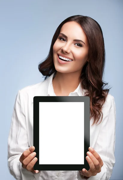 Businesswoman showing blank tablet pc, on grey