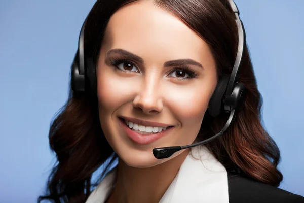 Customer support phone operator in headset, over blue