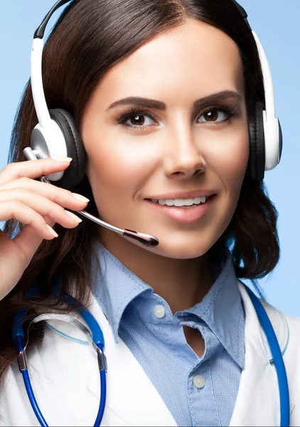 Happy smiling doctor in headset, on blue