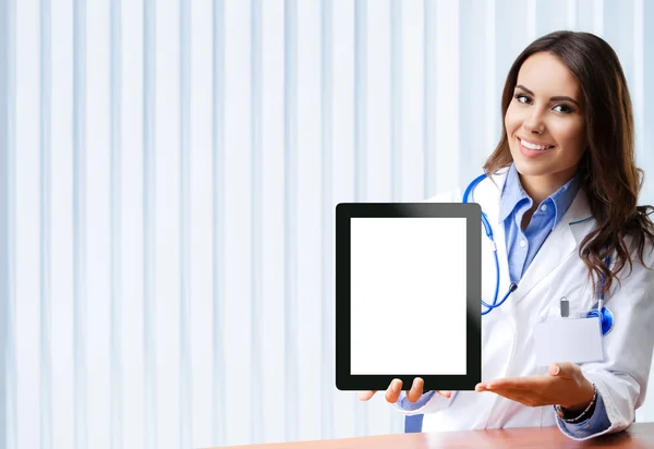 Doctor showing blank tablet pc for copyspace