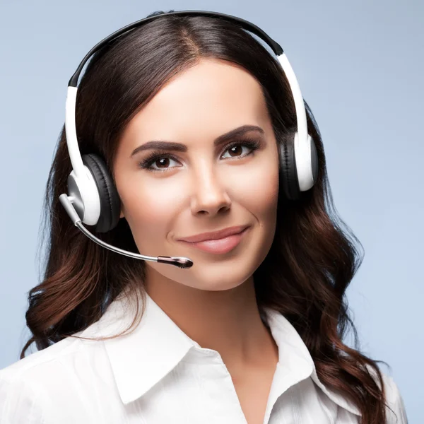 Portrait of cheerful customer support female phone operator in h