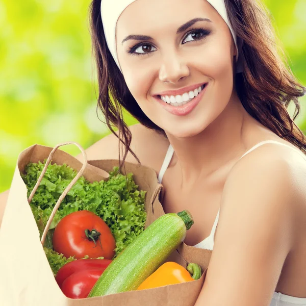 happy smiling woman in fitness wear with vegetarian food