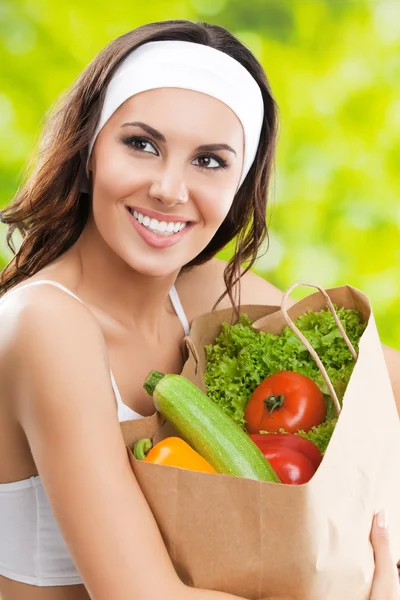 happy smiling woman in fitness wear with vegetarian food