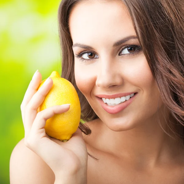Young happy smiling woman with limon, outdoors