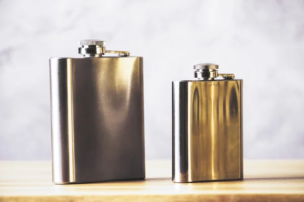 Flasks on wooden table