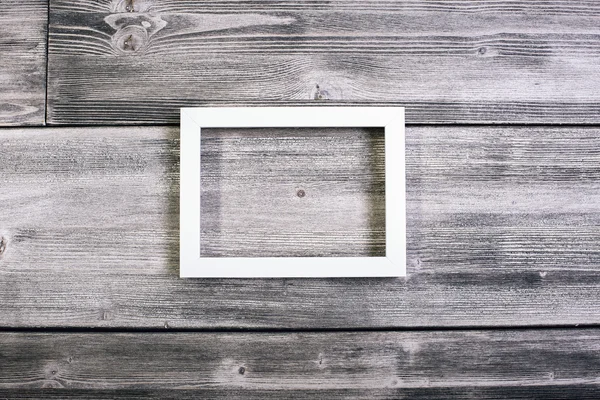 Rectangular see-through frame hanging on wooden wall. Mock up