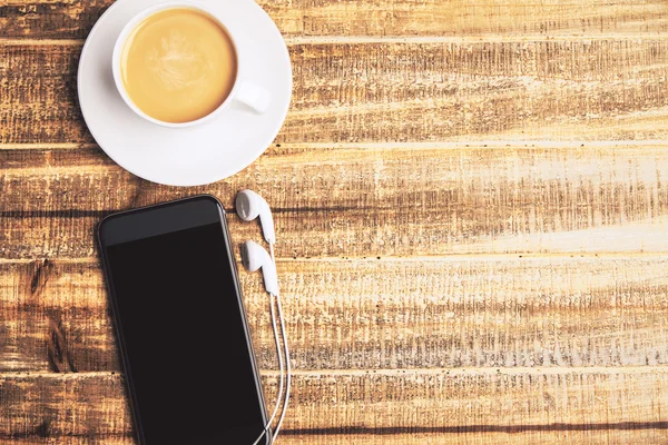 Coffee and phone on desktop