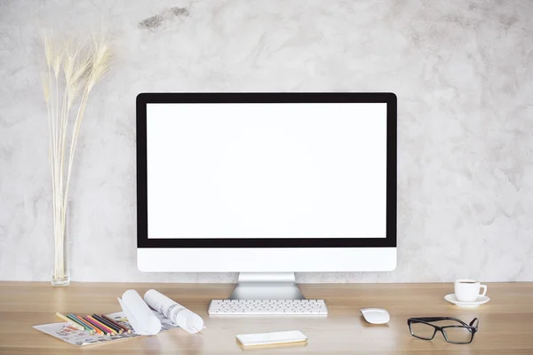 Creative desktop with blank monitor