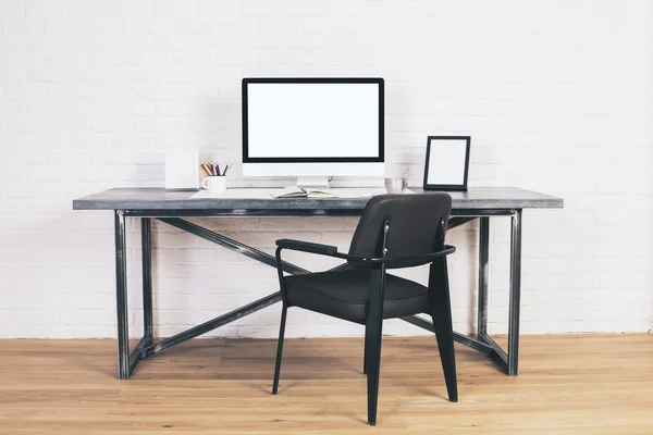 Black chair at designer desk