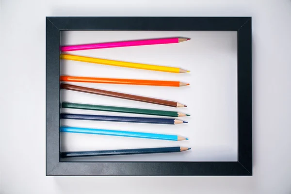Pencils inside picture frame