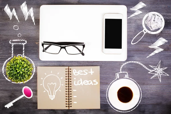 Top view of wooden desktop with coffee cup, plant, blank smartphone, glasses, abstract drawings and spiral notepad with lightbulb and \'best ideas\' text. Idea concept