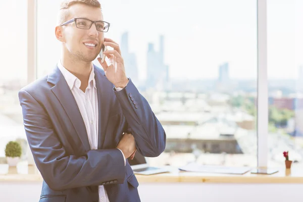 Happy businessman on phone