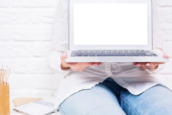 Woman showing white laptop