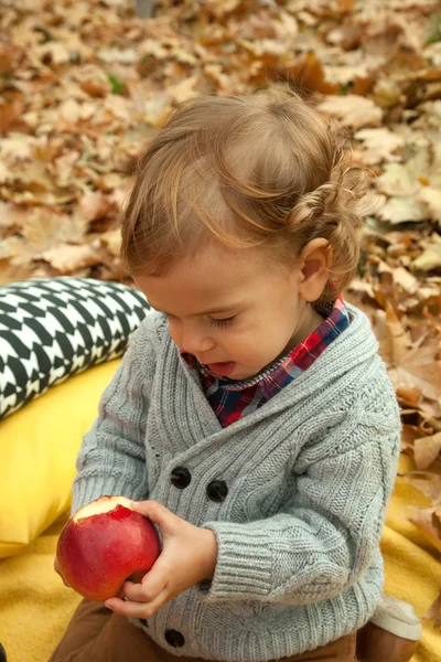 Boy  with apple in park