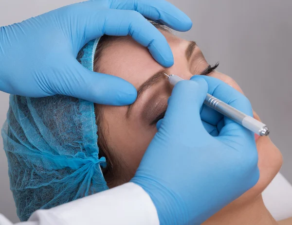 Young woman getting a permanent eyebrow make up treatment